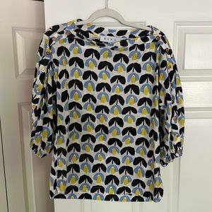 BURU cotton print top with gold buttons on sleeves.